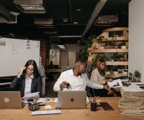 Omega Insurance Agency / about — a diverse group of co-workers having a casual discussion in the office